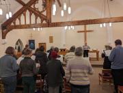 Music Director David Cooke helps the choir